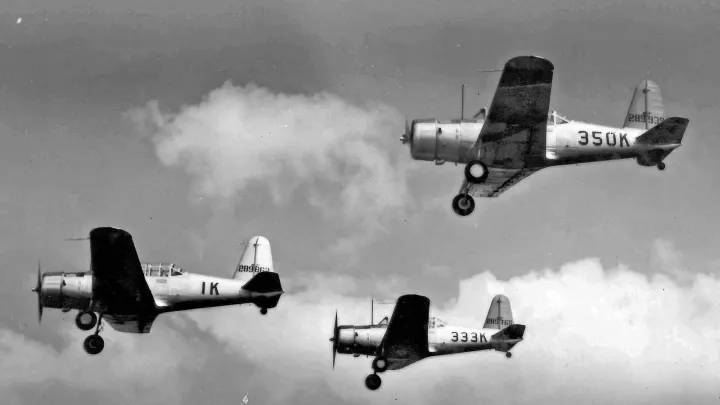 Three BT-13 trainers over Strother Field